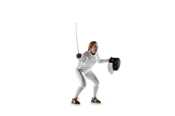 Close up of teen girl in fencing costume with sword in hand isolated on white studio background. Young female model in motion, action. Celebrating win emotional. Sport, youth, healthy lifestyle.