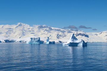 Mountains and icebergs among the islands around the Antarctic Peninsula, Antarctica