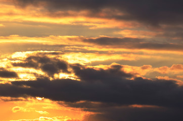 Sunset. Sky with clouds illuminated by sunlight.Background.