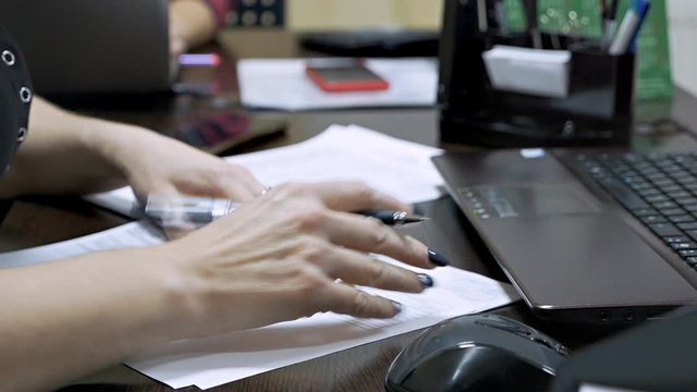 Medical researcher in a medical laboratory takes notes