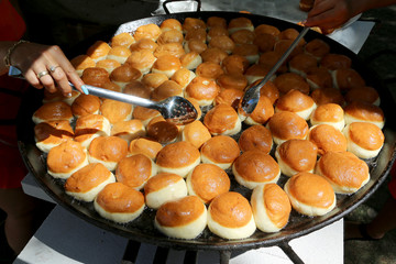 Crusty carnival donuts fried in oil on new years event