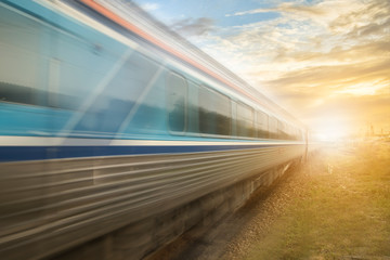 Classic train in motion with sunset the railway station local environment  classic intercity train on the railway. motion blur effect. old train speed concept.