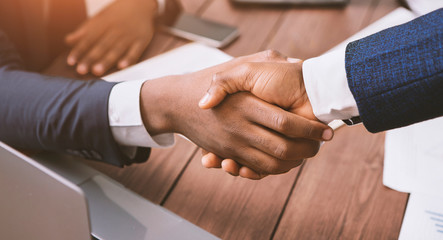Handshake of two african american businessmen at meeting