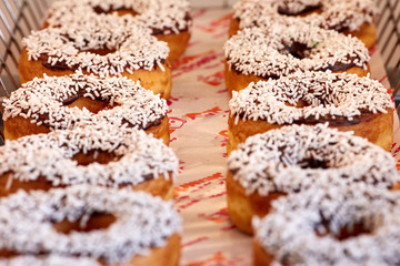 Set of colorful donuts on biege background. Top view.