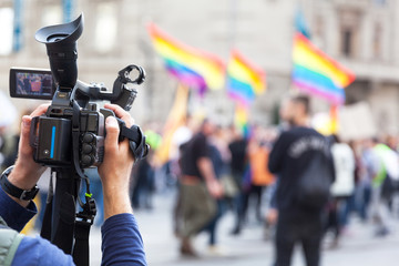 Camera operator recording LGBT parade or Gay pride