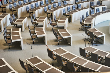 Empty row of chairs with work tables in the plenum of the Lower Saxony Parliament at the Open Day
