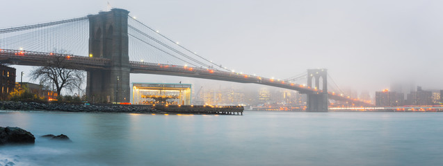 Brooklyn bridge at foggy rainy evening, New York City