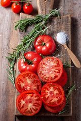Sliced Tomato. Red tomatoes on a Wooden Cutting Board.