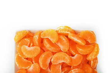 Juicy orange slices of MANDARIN in a rectangular white plate on a white background. Isolate.