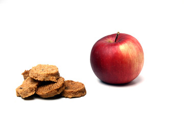 red apple and a pile of fruit candies isolated on white background