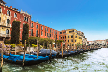 Fototapeta na wymiar View of the Grand canal, pier with gondolas and Rialto bridge on the horizon, Venice, Italy