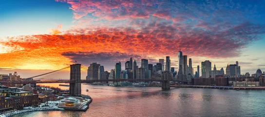 Poster Panoramisch uitzicht op Brooklyn bridge en Manhattan bij levendige zonsondergang, New York City © sborisov