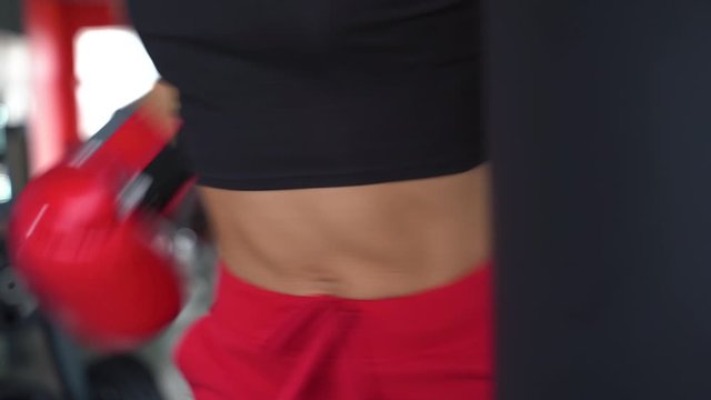Young adult sportwoman making work out exercise in gym
