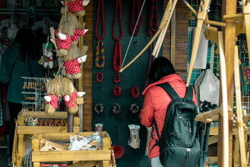 Woman in a rustic gift shop. Woman chooses a gift in a souvenir shop