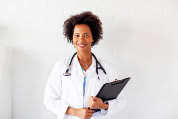 Woman doctor standing with stetoscope over her neck