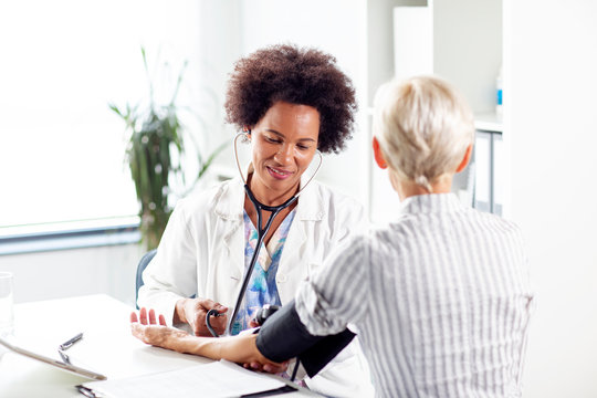 Doctor Measure Blood Pressure In Ambulance Older Woman