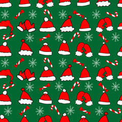 Seamless pattern, set of cute hand-drawn red and white hats on green background. Caps with white fluff around the edges and with a pompoms. Between the caps are sweets, candies and white snowflakes.