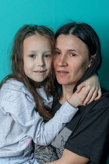 Studio photo of a young girl in glasses on a colored background