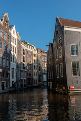 Fototapeta na wymiar A picturesque place with old buildings in the old district of Amsterdam