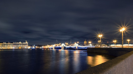 Panorama of the night city  Saint Petersburg before Christmas. Neva River, Palace Bridge, St. Isaac's Cathedral and the building of the Winter Palace in festive night illumination