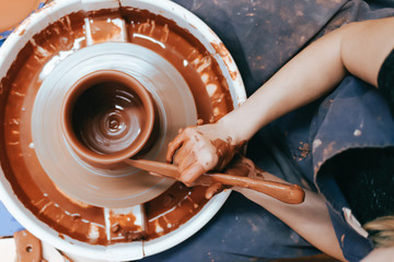 Potter gives final shape to clay product