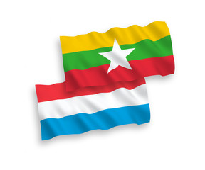 Flags of Myanmar and Luxembourg on a white background