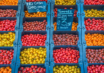 Various different cherry tomatoes offered on a market 