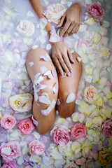 Beautiful girl in the bathroom with many flowers.