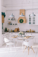 Interior of a bright modern kitchen in vintage style, decorated with Christmas decor