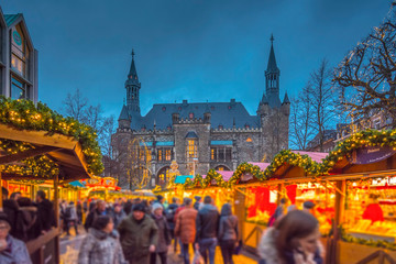 Aachen city hall with its annual Christmas market during blue hour 