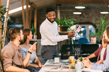 Creative designers discussing work, choosing color design