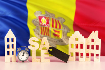 Andorra real estate sale concept. Wooden house model with discount tag on national flag background. Copy space for text.