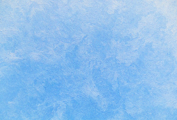 Venetian stucco of blue color with white stains. Background and texture of decorative plaster.