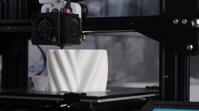 The 3D printer prints the model out of white plastic. Modern techology. 4K