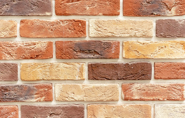 Brick wall of multicolored bricks. Background and texture of brickwork.