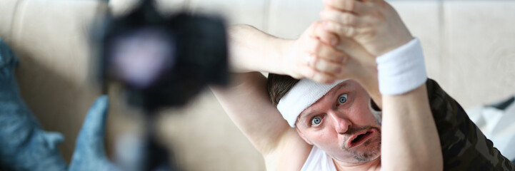 Blogger Man with Funny Face Doing Exercise for Leg