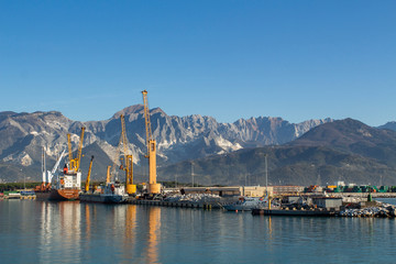 Italy, Tuscany: view of the port in Marina di Carrara and in the background the Apuan Alps with the marble quarries