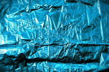 Background with blue wrinkled foil wrapping paper