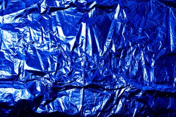 Background with blue wrinkled foil wrapping paper