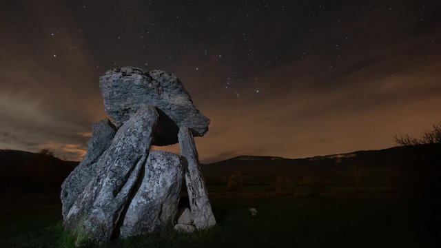 Ancient dolmen against night sky