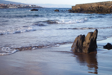 Close-up of some rocks on a rocky beach with volcanic sands