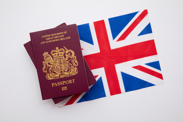 United Kingdom travel passport on a Great Britain Union Jack flag