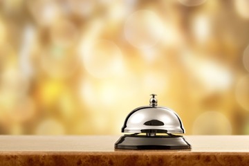 Hotel classic ring with wooden table on background.