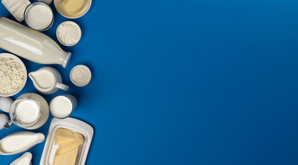 Dairy products on blue wooden background, top view