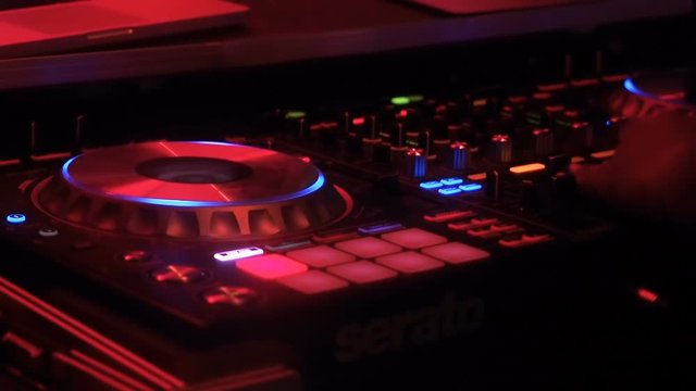 Koh Phangan, Thailand, May 19, 2019: Boy DJ at beach club playing mixing music in Full Moon party on island Koh Phangan, Thailand