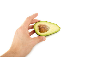 cropped view of man holding avocado half with seed isolated on white