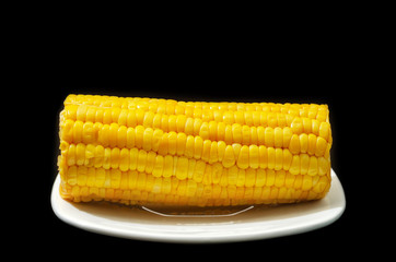 Corn cob close up on black background