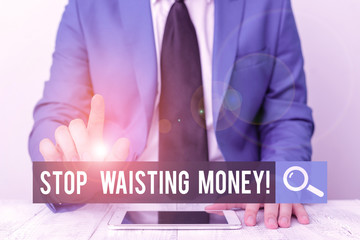 Writing note showing Stop Wasting Money. Business concept for advicing demonstrating or group to start saving and use it wisely Businessman with pointing finger in front of him