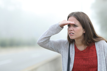 Woman trying to watch a foggy day
