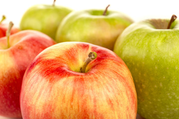 close up view of red and green ripe fresh apples isolated on white